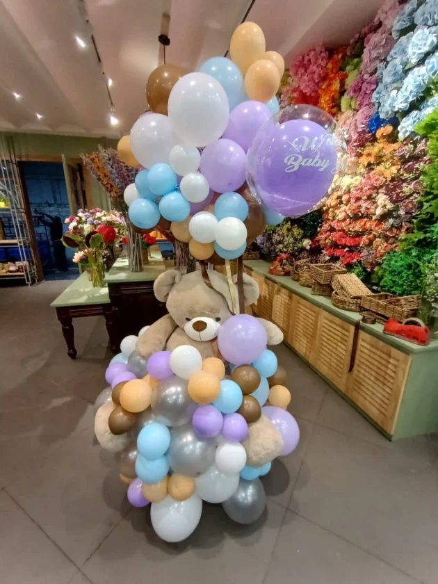 Giant teddy holding balloon cloud for you