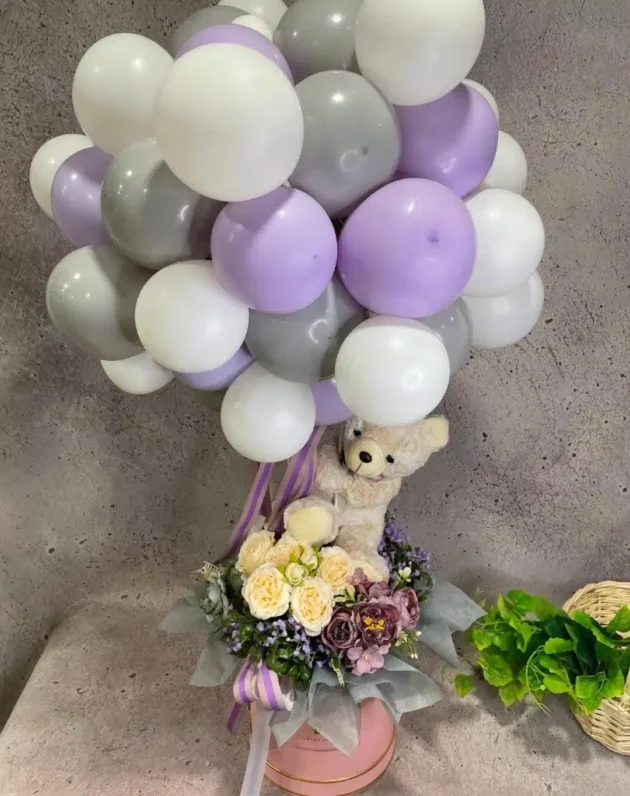 Teddy holding a giant balloon cloud