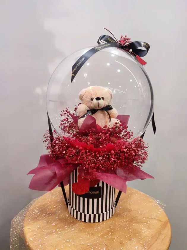 Teddy inside with gypso arrangement