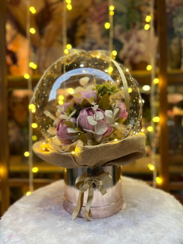 artificial flowers inside balloon