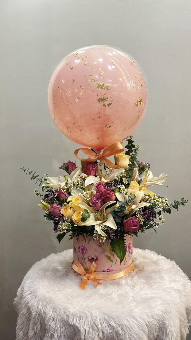 fresh flower arrangement with gold foil balloon