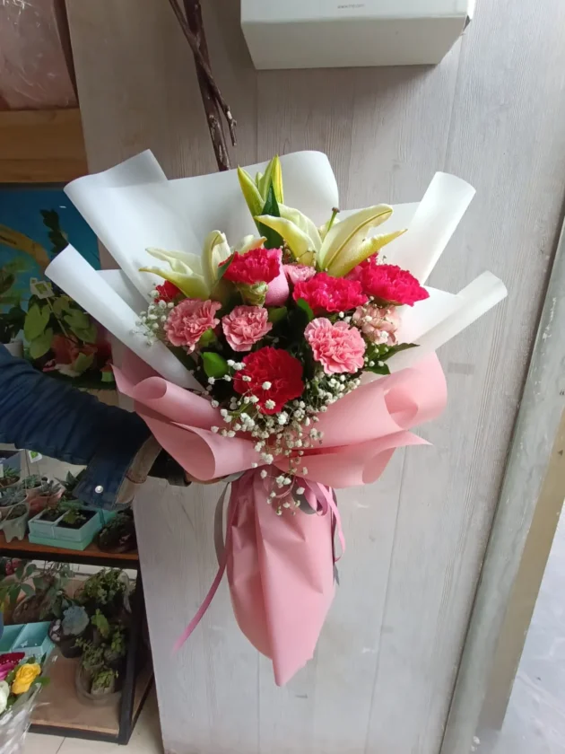 dark pink carnation and lily with light pink hue